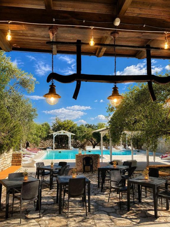 a patio with tables and chairs and a pool at Agriturismo Le Matinelle in Matera