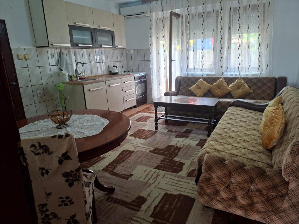 a living room with a couch and a table at Roof - Holiday Home in Gjakove