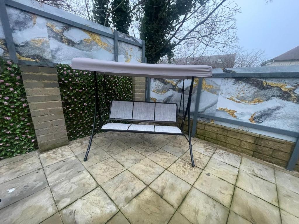 a swing chair sitting on top of a patio at Silverhill in Bradford