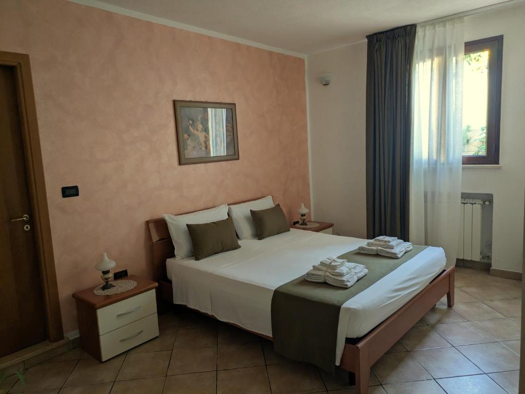 a bedroom with a large bed and a window at Casa Santa Iaca in Vitigliano