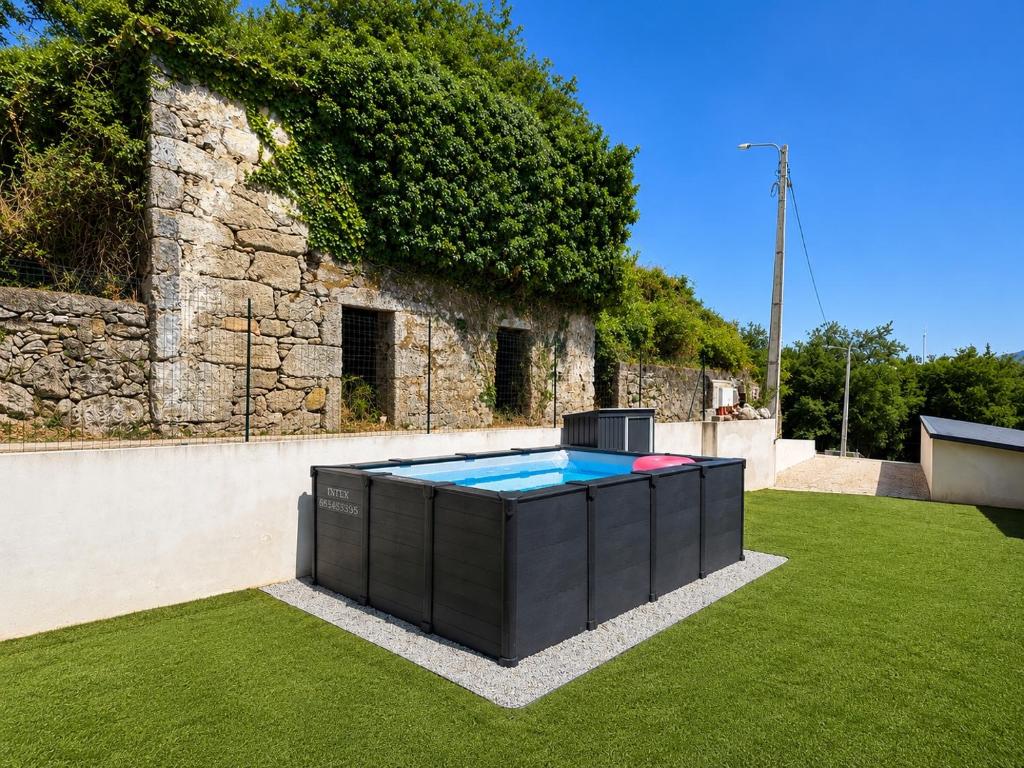 a pool in the yard of a house at Casa das Abelhas in Arcos de Valdevez