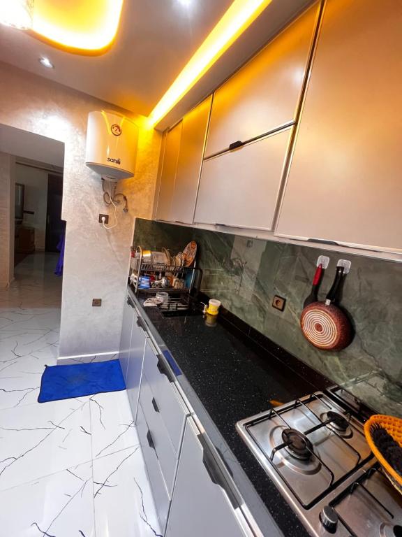 a kitchen with a stove and a counter top at Stoph in Beni Mellal