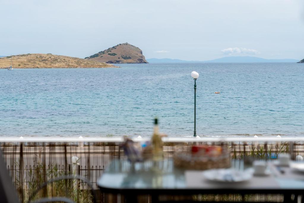 a table with a view of a body of water at Porto Marina SeaView in Porto Rafti
