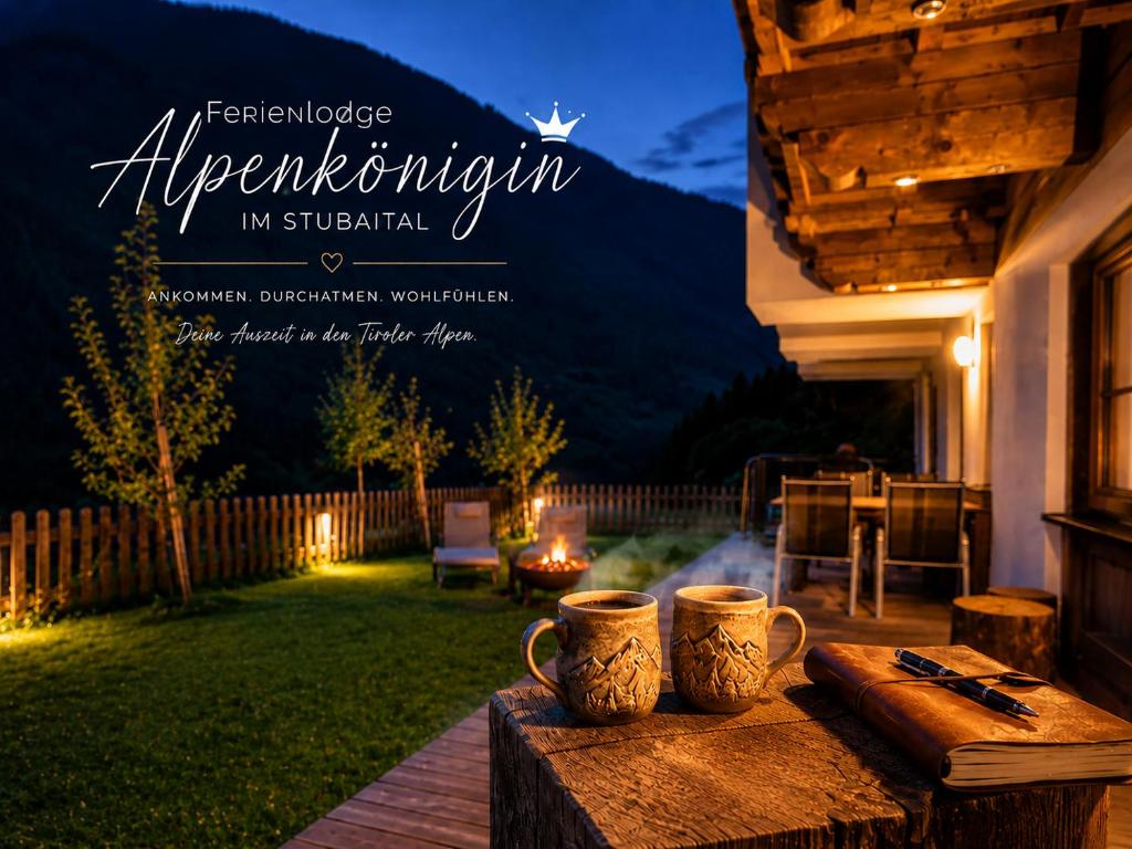 two coffee mugs sitting on a wooden table in a backyard at Ferienlodge Alpenkönigin Vacation in Stubai Valley in Neustift im Stubaital
