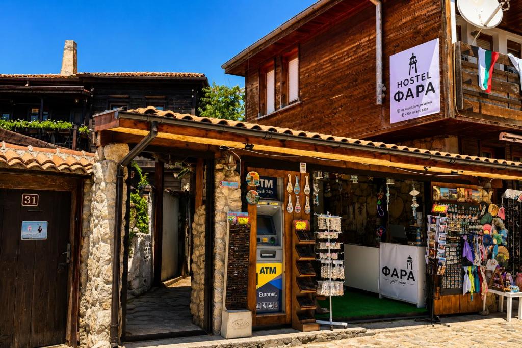 a store front of a building with a sign on it at hostel FARA in Nesebar