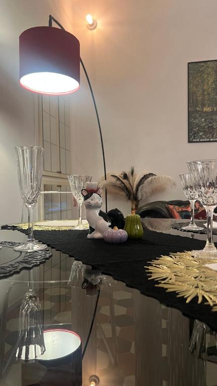 a room with a table with glasses and a lamp at Domus Gaia in Rome