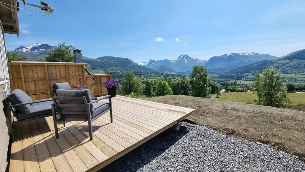 a deck with two chairs on top of a house at Brudevoll Gard in Ørsta