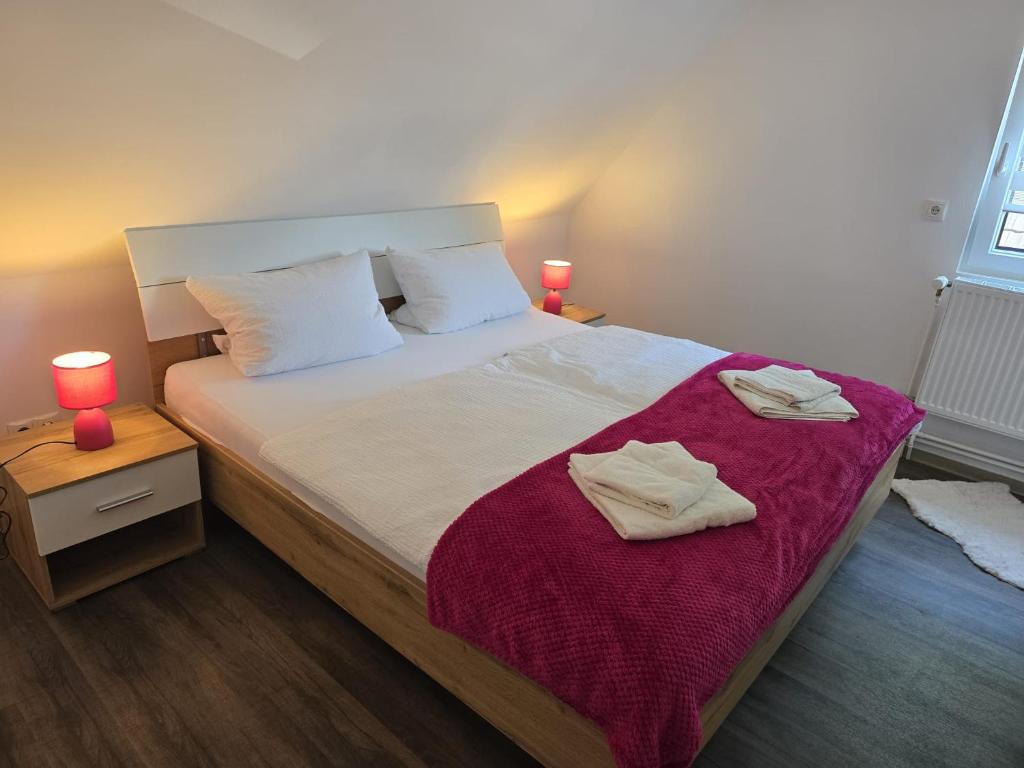 a bedroom with a large bed with two towels on it at Ferienhaus am Bethlehem Kanal in Papenburg