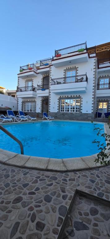 a building with a swimming pool in front of a building at Villa golden life apartments, new property with pool access in Luxor