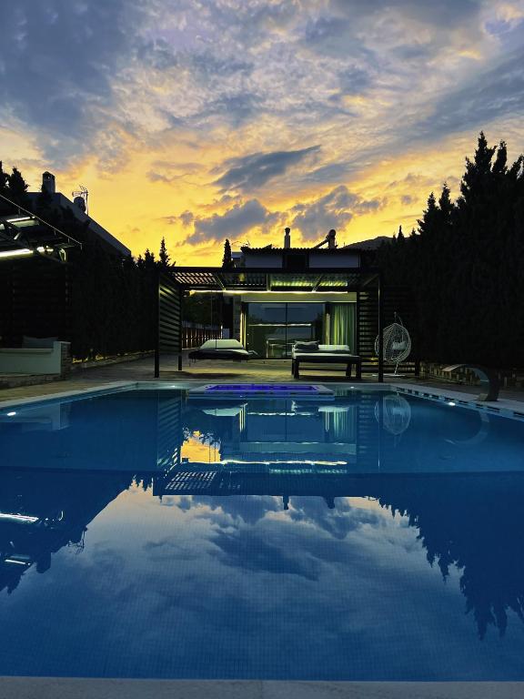 a house with a pool in front of it at Private Pool House for 6 by Olivujoj in Anavyssos