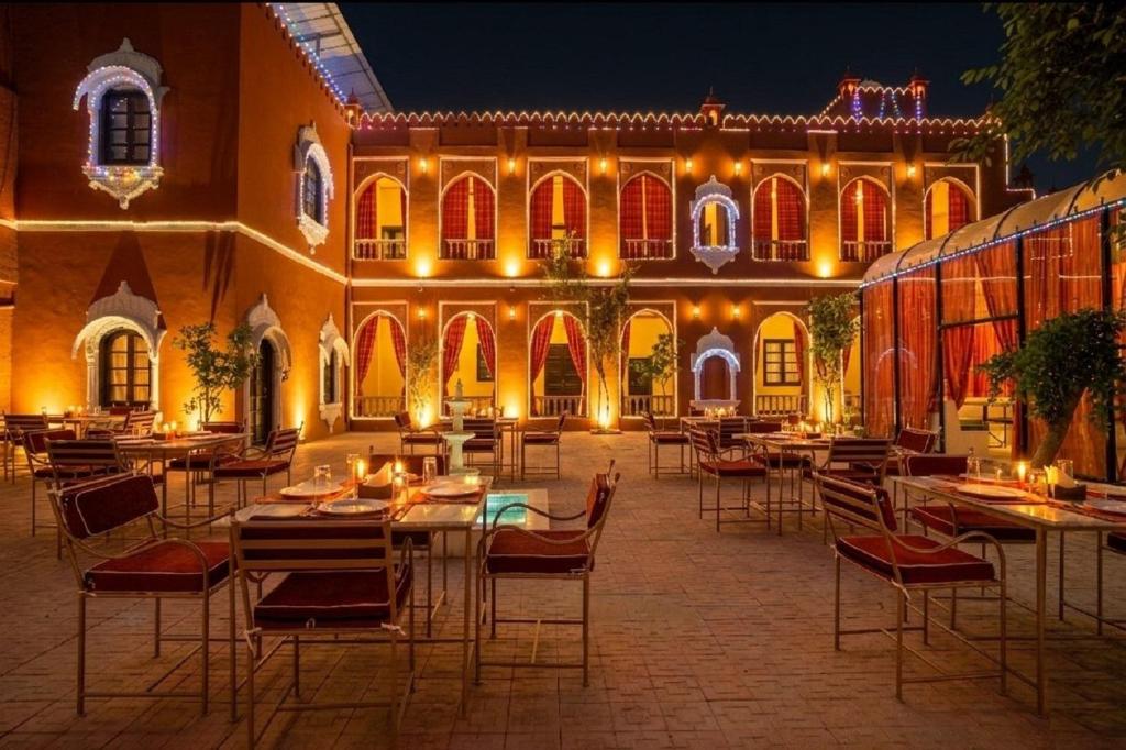 a courtyard with tables and chairs in front of a building at Garrison at Dera Bagseu in Bikaner