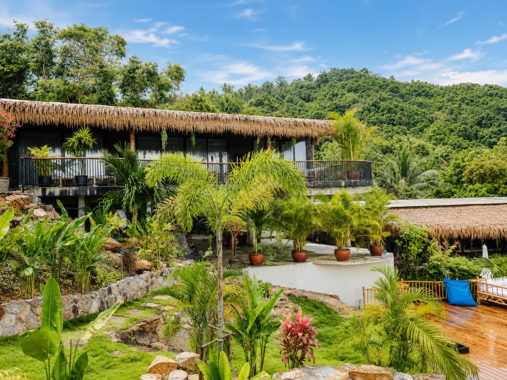 a resort with palm trees in front of it at SANA Koh Phangan in Salad Beach