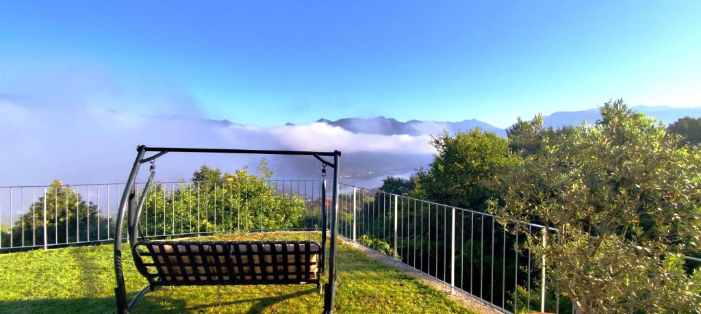a bench sitting in the grass near a fence at Puro Wild in Geres