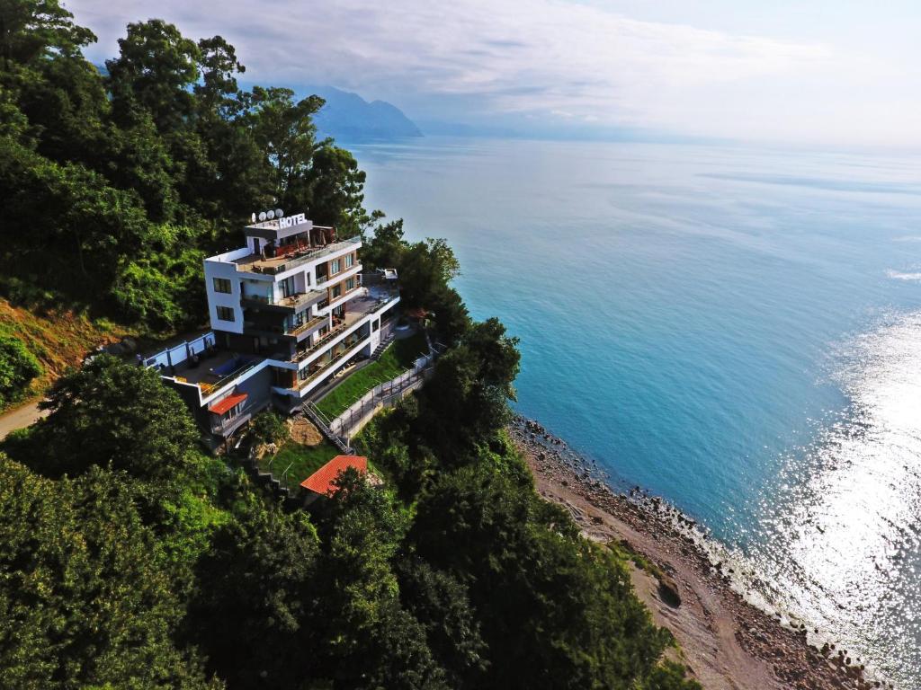 an aerial view of a building on a hill next to the ocean at Hotel Montana in Sarpi