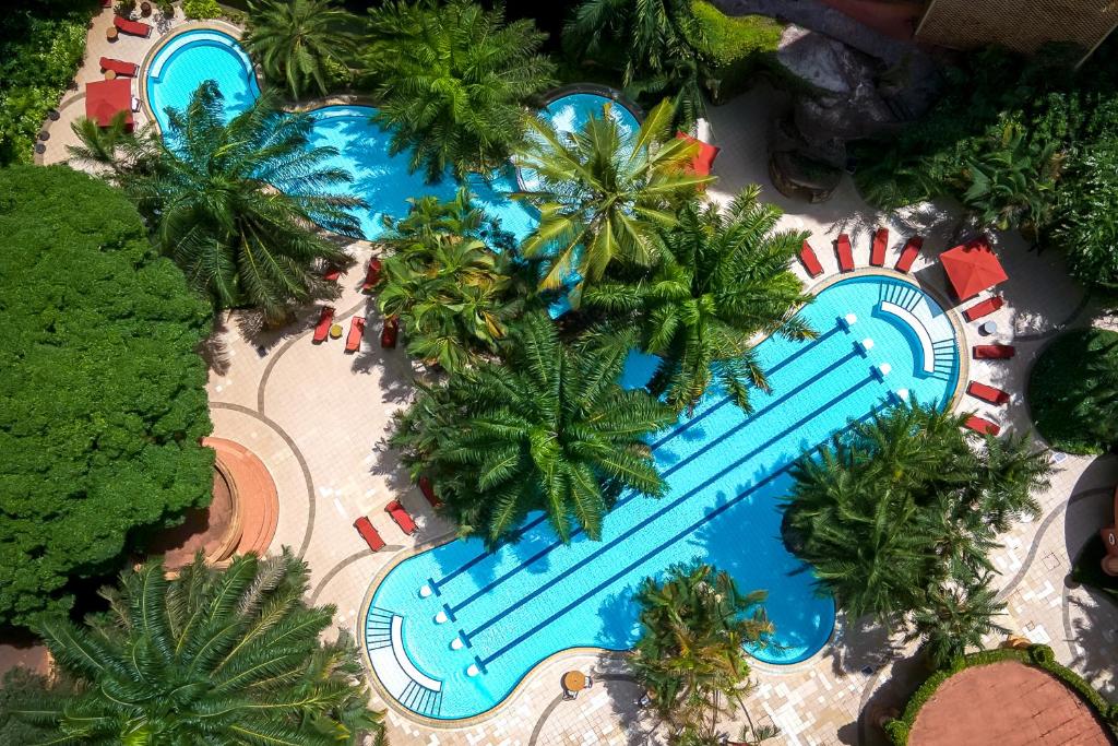 an overhead view of a resort swimming pool with palm trees at Kampala Serena Hotel in Kampala