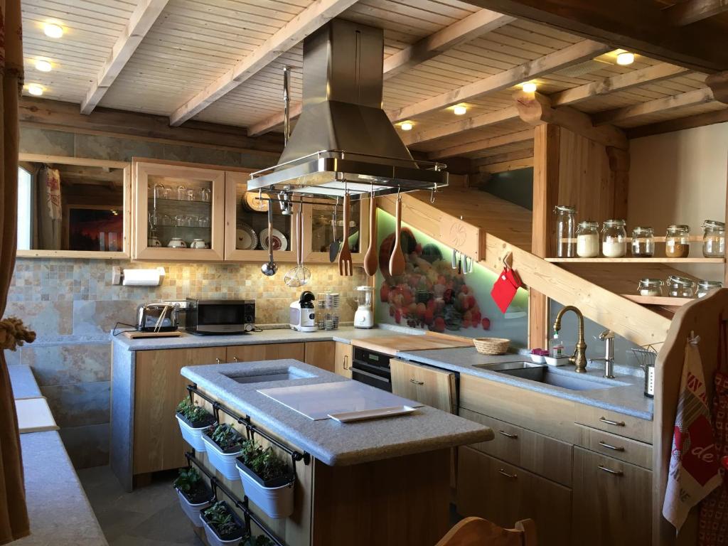 a kitchen with a sink and a stove top oven at Le grenier des rêves in Les Deux Alpes
