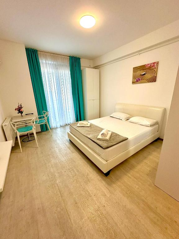 a bedroom with a bed and a table in it at Mario Summerland Property in Mamaia