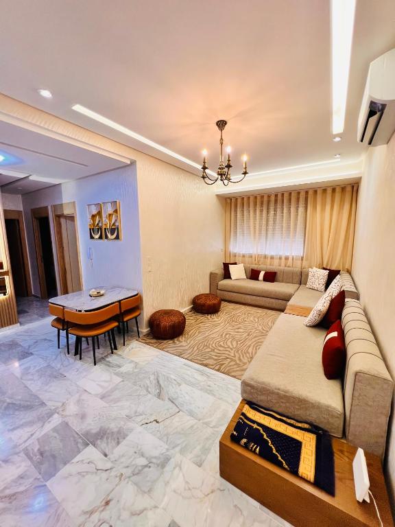 a living room with a couch and a table at Luxury Appartement fes city fleur in Fez