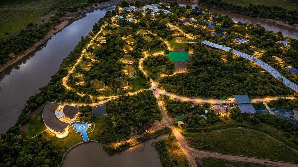 an aerial view of a park next to a river at night at Pristine Mara Bay Lodge in Masai Mara