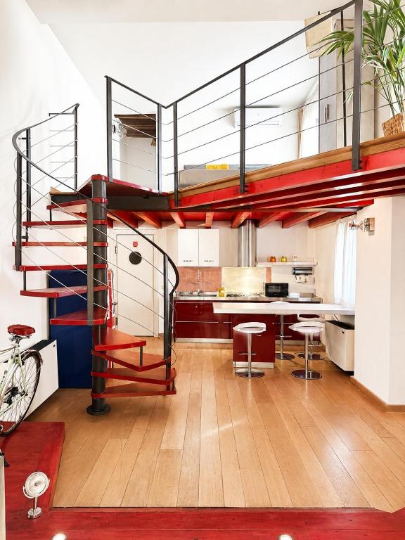 a kitchen with a spiral staircase in a loft at al home in Crema