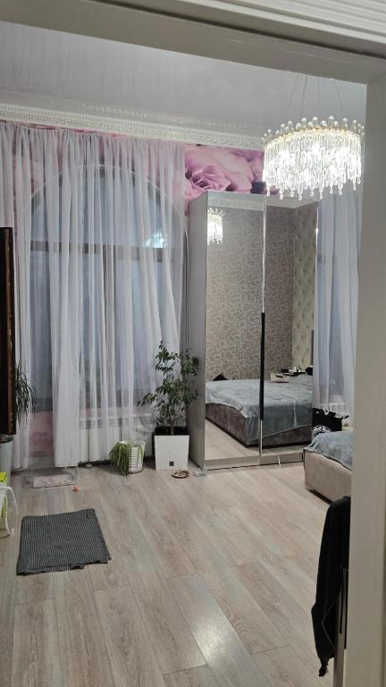 a bedroom with a bed and a large mirror at Aura in Dzerzhinskoye