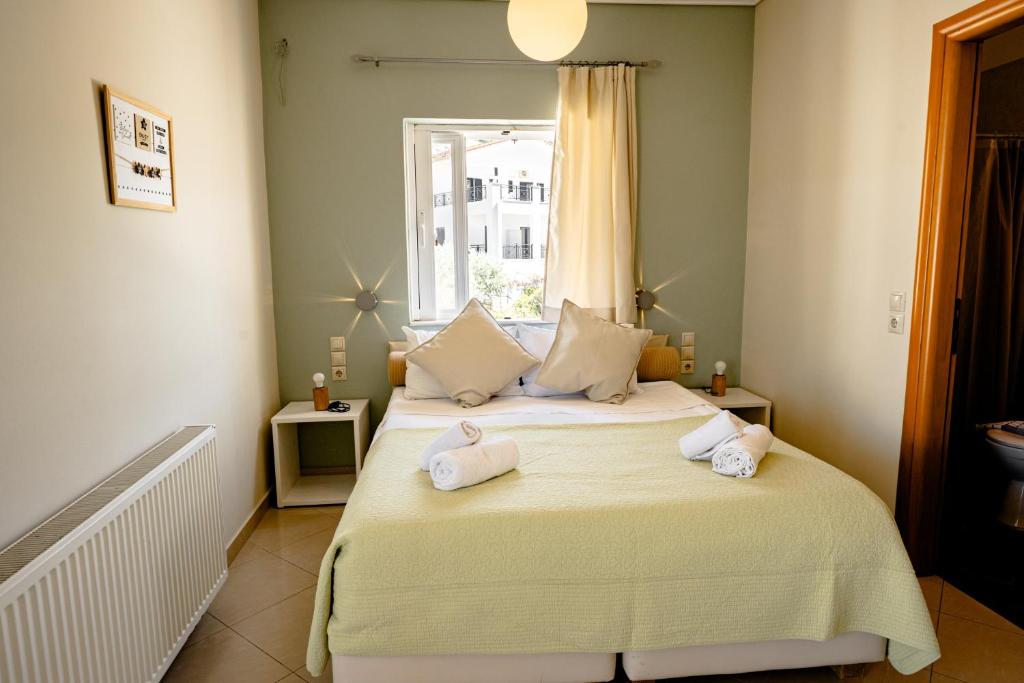 a bedroom with a bed with towels on it at Villa Muses in Poros