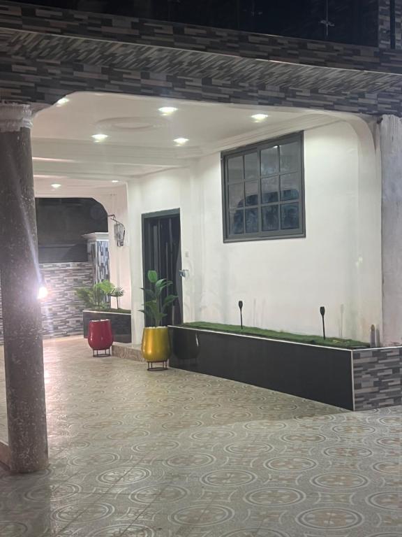 a lobby with a waiting area with a table and chairs at Kingdom home in Amanfro