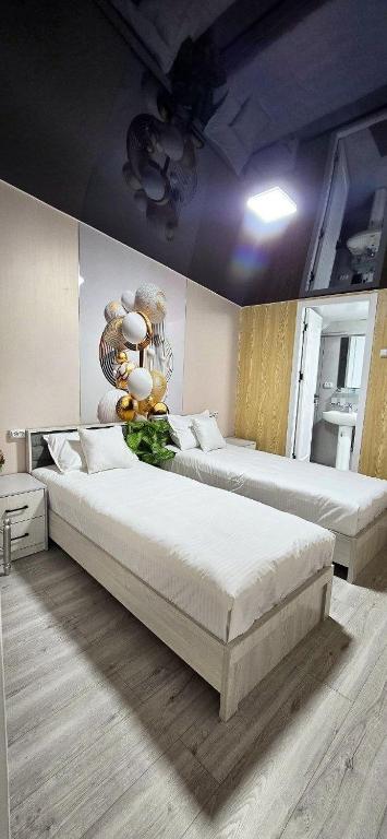 a bedroom with two beds in a room at Welcome Hotel in Tashkent
