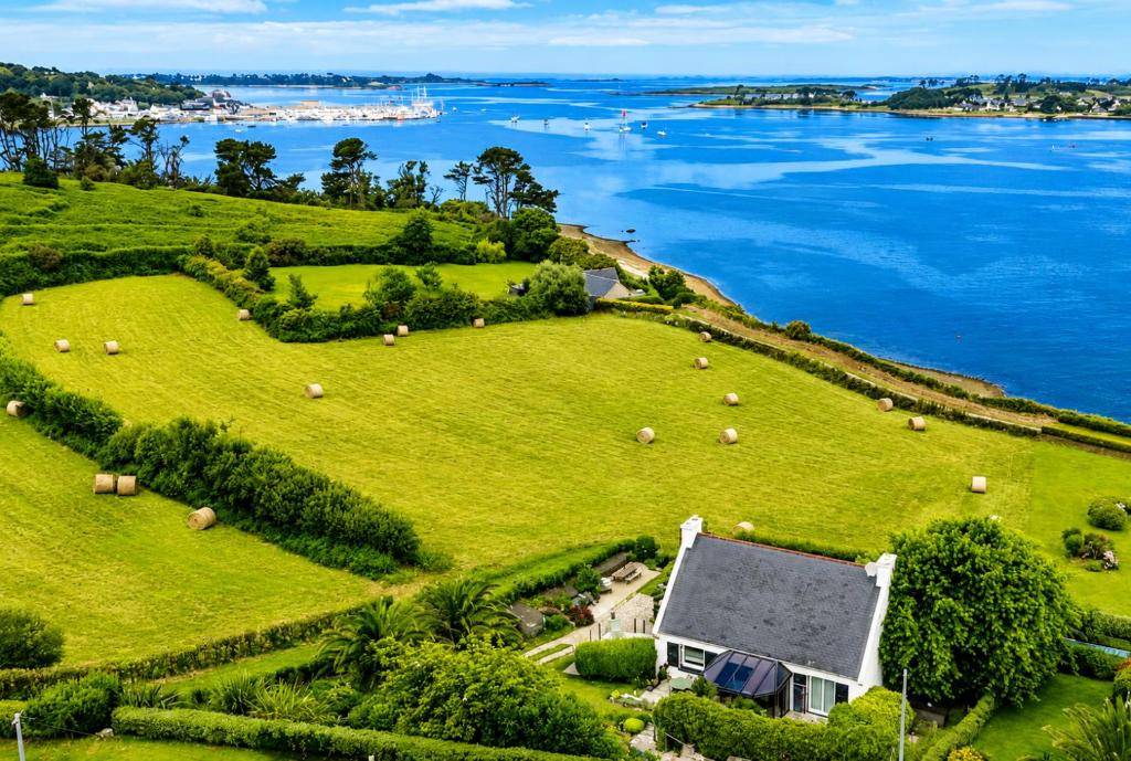 an aerial view of a farm with animals on a field at Maison vue mer incroyable 180 degrés , accès direct plage et GR34 in Landéda