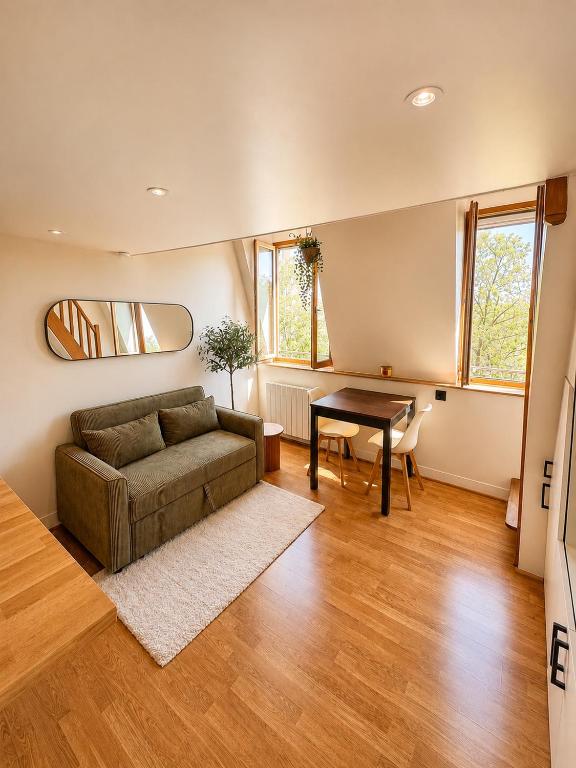 a living room with a couch and a table at Charming Duplex by Vincennes Castle in Vincennes