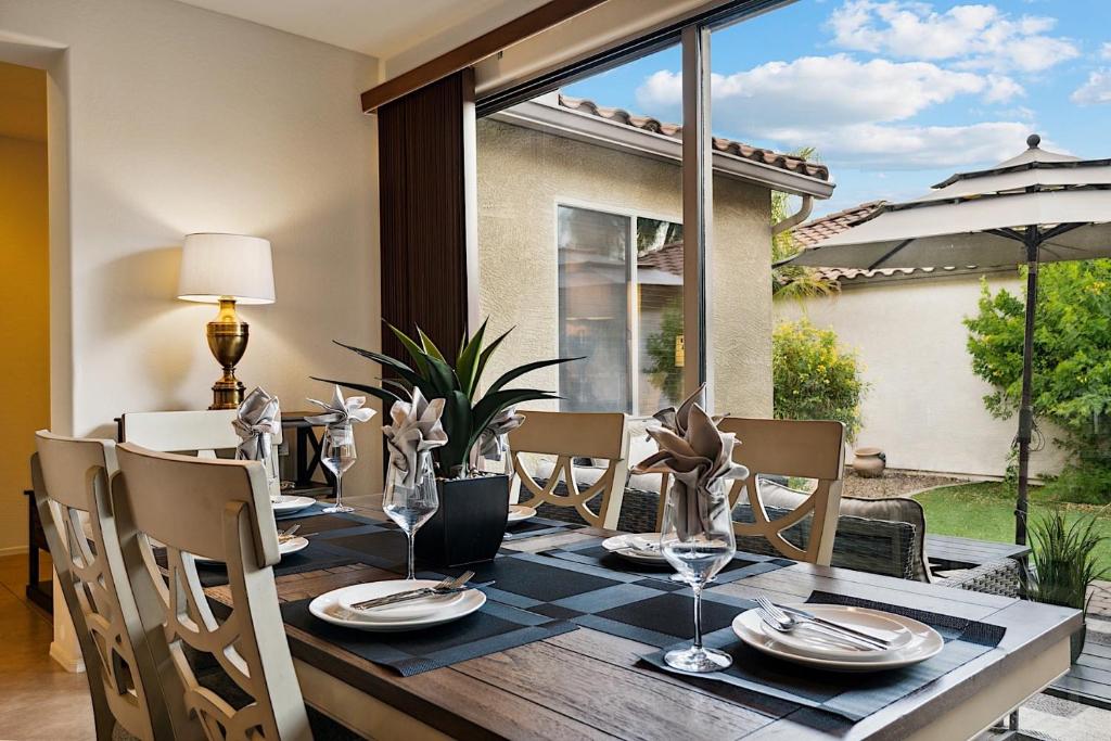 a dining room with a table and chairs and a window at Getaway at Power Ranch in Gilbert