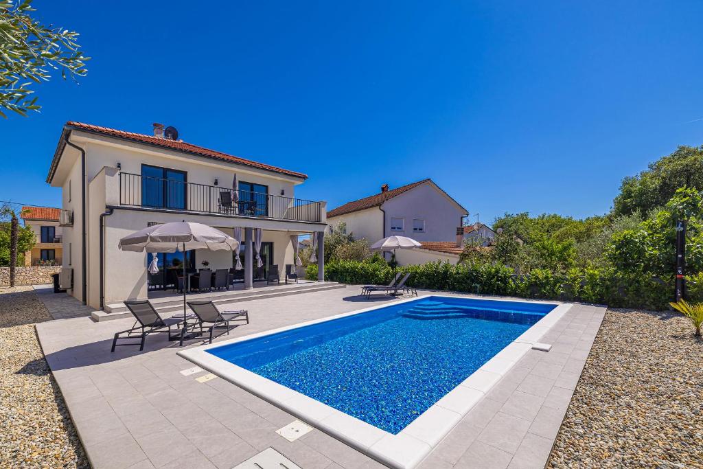 an image of a villa with a swimming pool at Villa MARIS with private pool in Sveti Vid-Miholjice