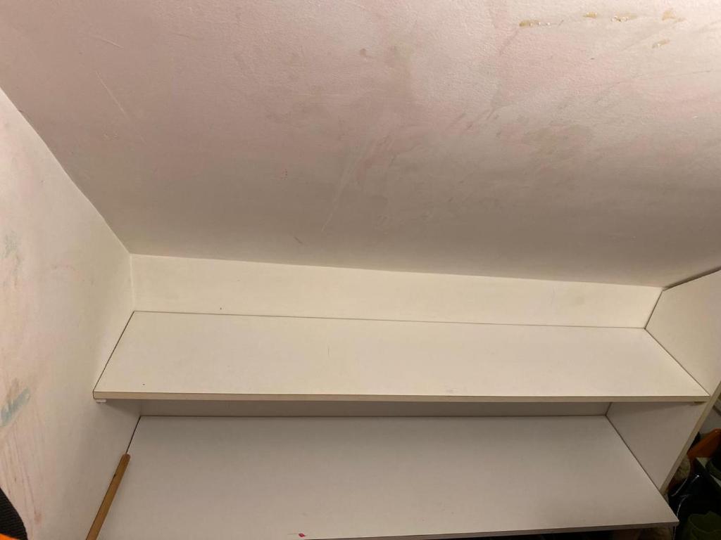 a white shelf in a room with a ceiling at Cœur de Troyes studio in Troyes