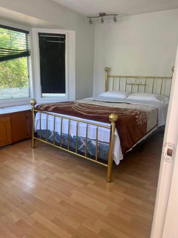 a bedroom with a bed in a room with a window at six bedroom house in Victoria