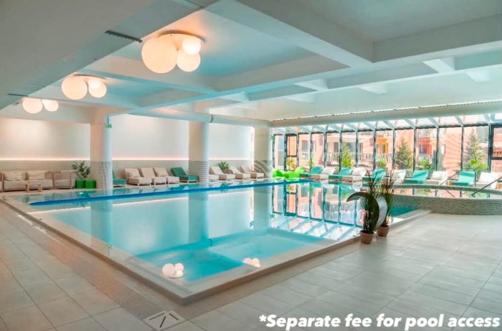 a swimming pool in a building with a pool at Alpine Line Studio with pool & spa in Sinaia