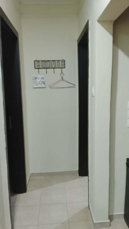 a room with two doors and a sign on the wall at Naomi Home in Alexandroupoli
