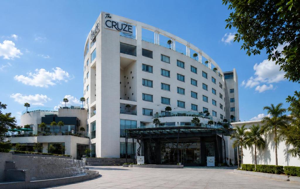 a white building with a sign on it at THE CRUZE PREMIUM BOUTIQUE HOTEL in Jamshedpur