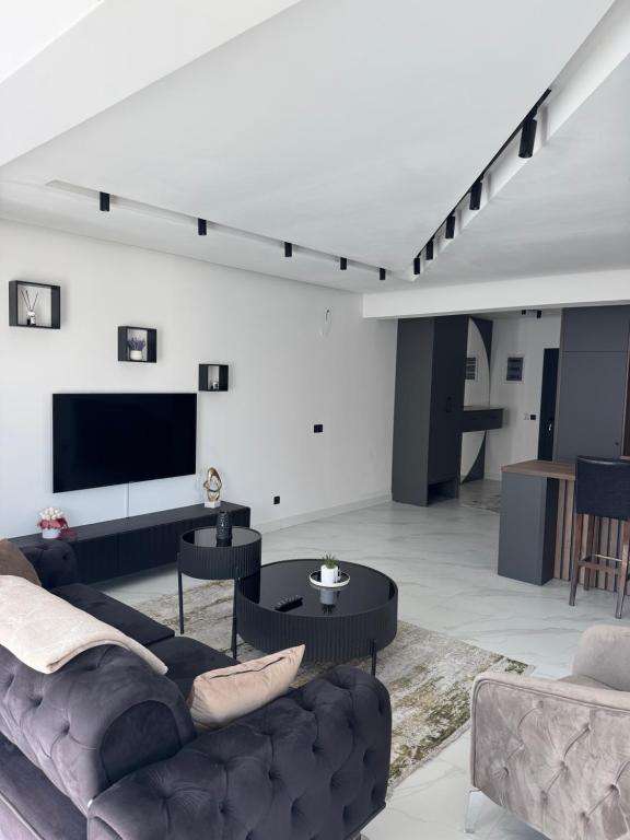 a living room with a couch and a flat screen tv at AD Home in Bar