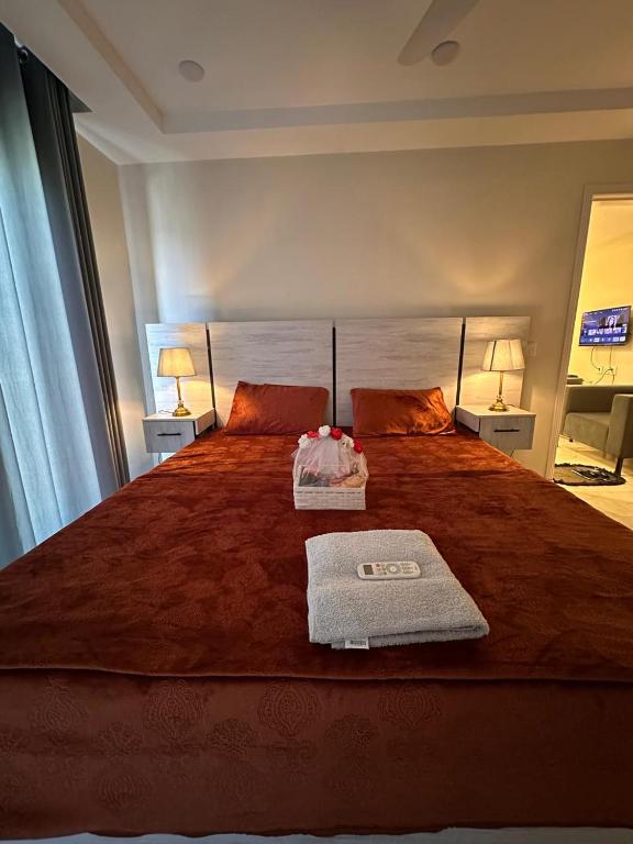 a bedroom with a large bed with two towels on it at 1 BHk, Bed Hall Kitchnett in Lahore