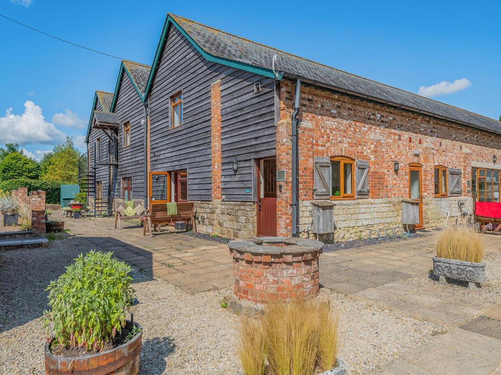 an old brick house with a patio in front of it at Granary - Uk49910 in Blandford Forum
