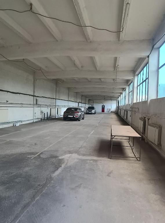 a parking garage with two cars parked in it at parcare privata doar pentru autoturisme in Braşov