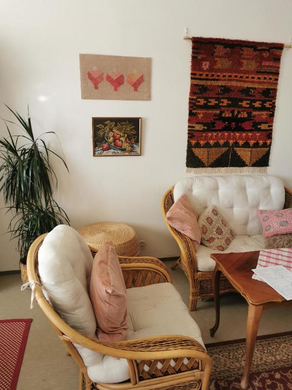 a living room with wicker chairs and a couch at Maribo Street Home in Kaskö