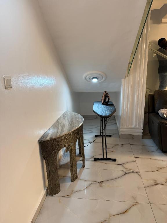 a living room with a stool and a table at Asibbey Lodge in Maijaw