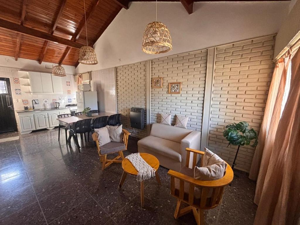 a living room with a couch and chairs and a table at Casa en Berazategui in Plátanos