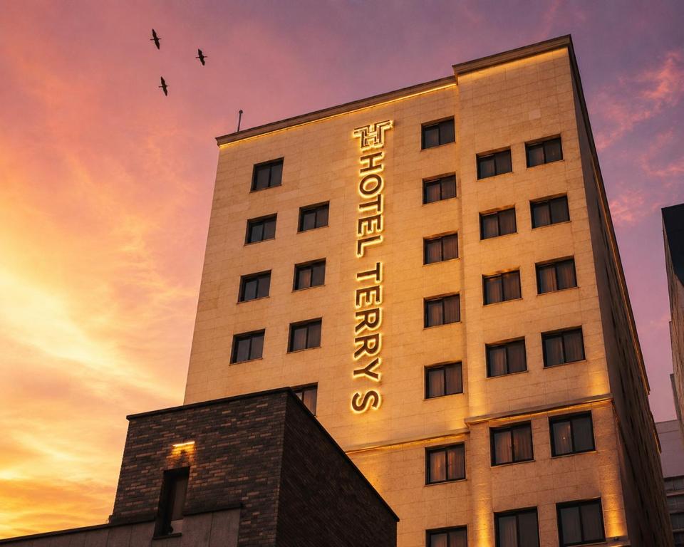 a building with a hotel sign on top of it at Hotel Terry's in Suwŏn-yŏk