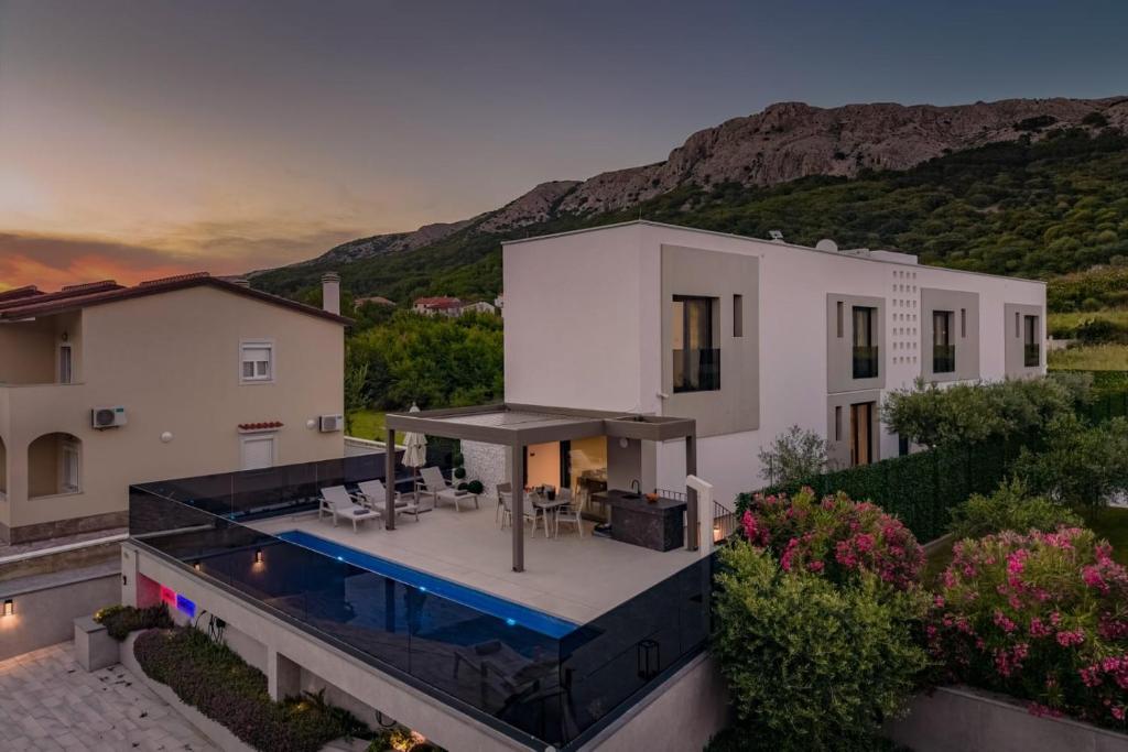 an aerial view of a house with a swimming pool at Villa Sunset with swimming pool in Baška