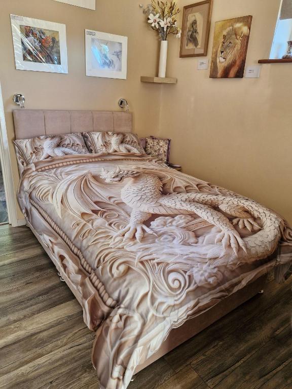 a bed with a dragon carved into it in a bedroom at Art House in Portsmouth