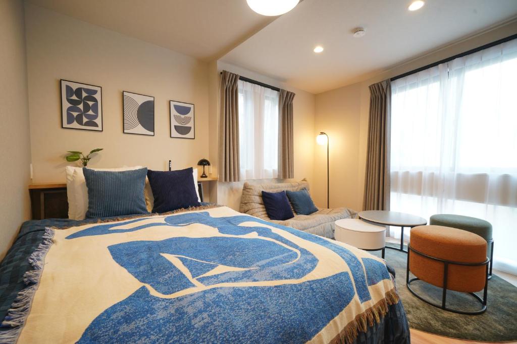 a bedroom with a bed and a living room at LinksHotel 西荻窪 in Ogikubo