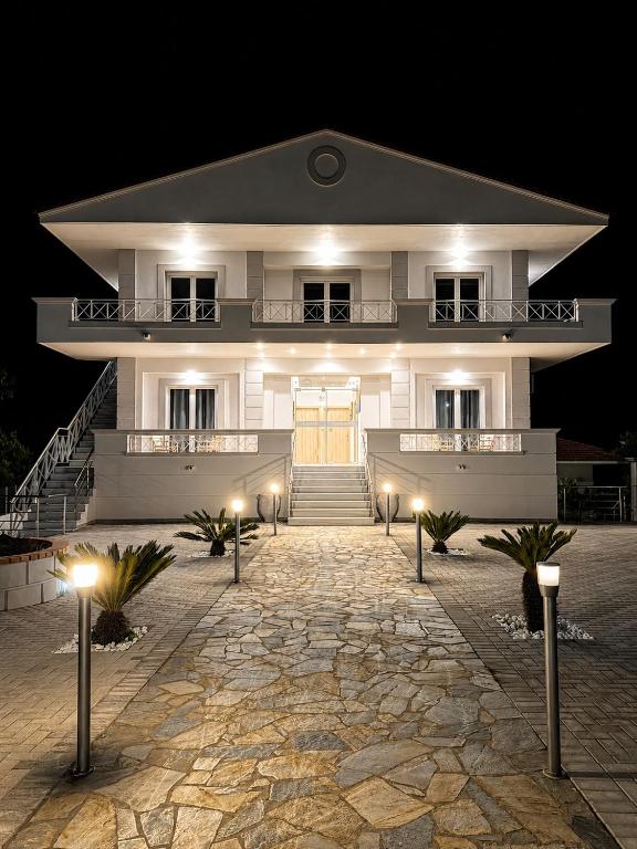 a large white building with lights in front of it at VILLA Konstantinos in Agios Georgios