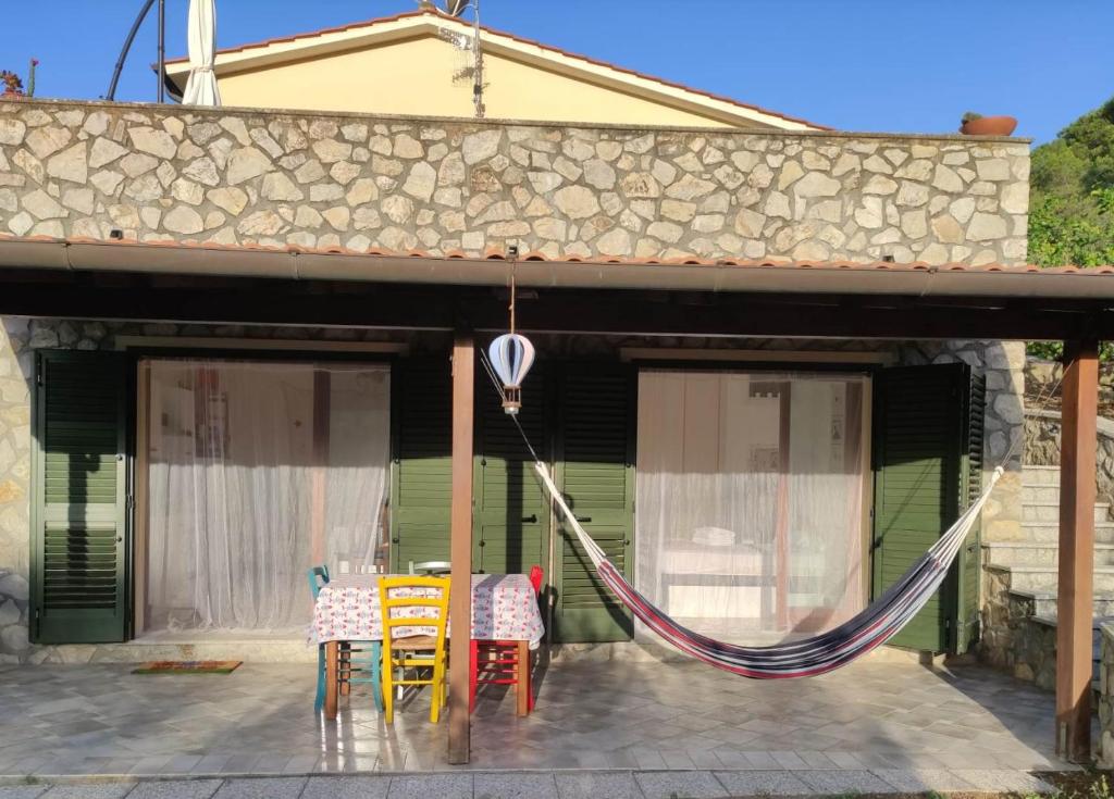 a patio with a table and chairs on a house at CASA LACONA in Lacona